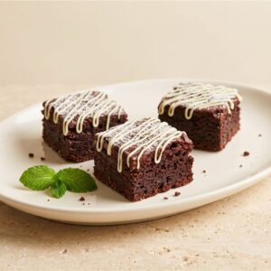 Midnight Chocolate Brownie Bites with white chocolate drizzle — illustrative serving presentation